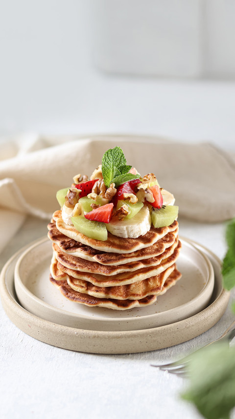 Pancakes with fruits and berries on the white background screenshot