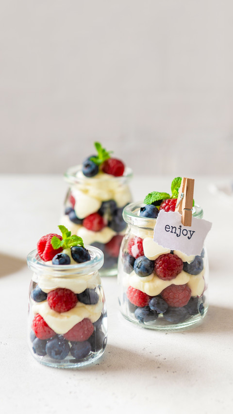 Raspberry and blueberry parfait with cheese cream in jars screenshot