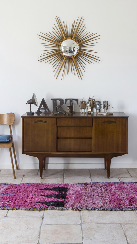 Exotic wood sideboard below sunburst mirror and various screenshot