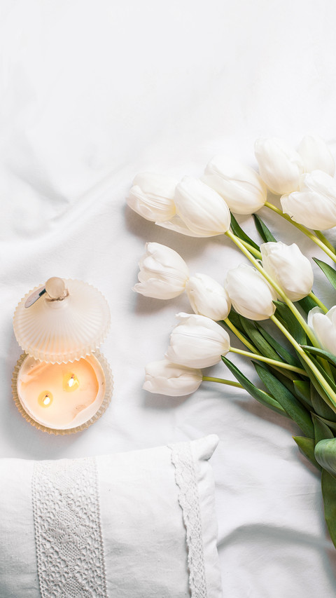 Spring Flowers Tulips with Candles and White Pillows screenshot