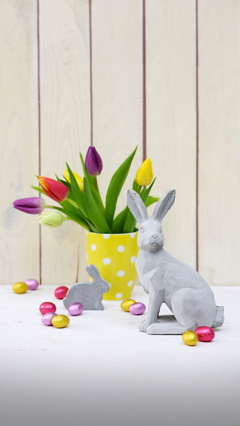 Easter arrangement of concrete rabbit ornament and vase screenshot