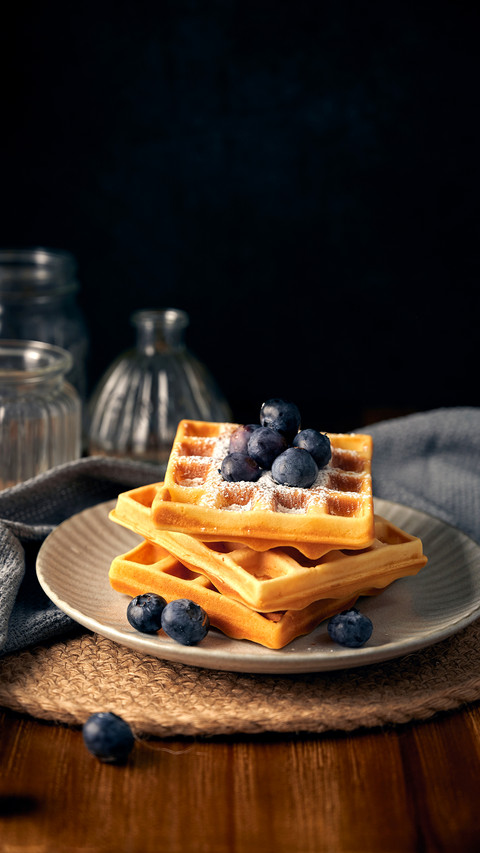 Honey blueberry waffles in front of dark background screenshot