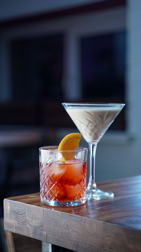 Classic cocktails on a wooden table in a loft bar screenshot