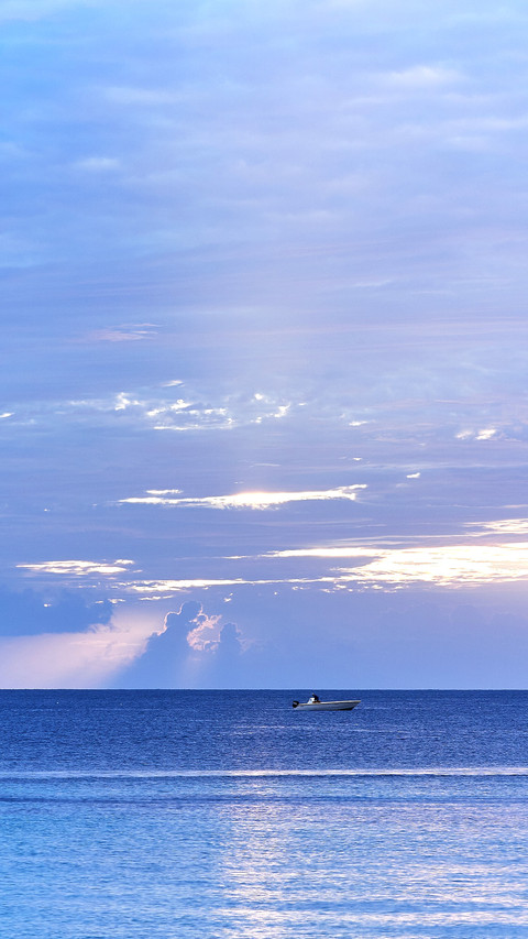 A catamaran anchored in the Caribbean Sea at sunset screenshot