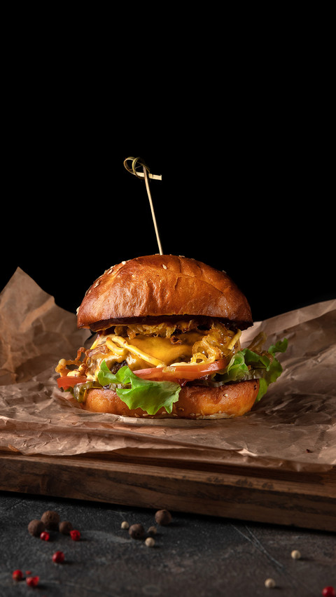 Big classic burger with beef on a black background screenshot