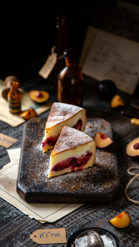Two slices of baked cheesecake on wooden board screenshot