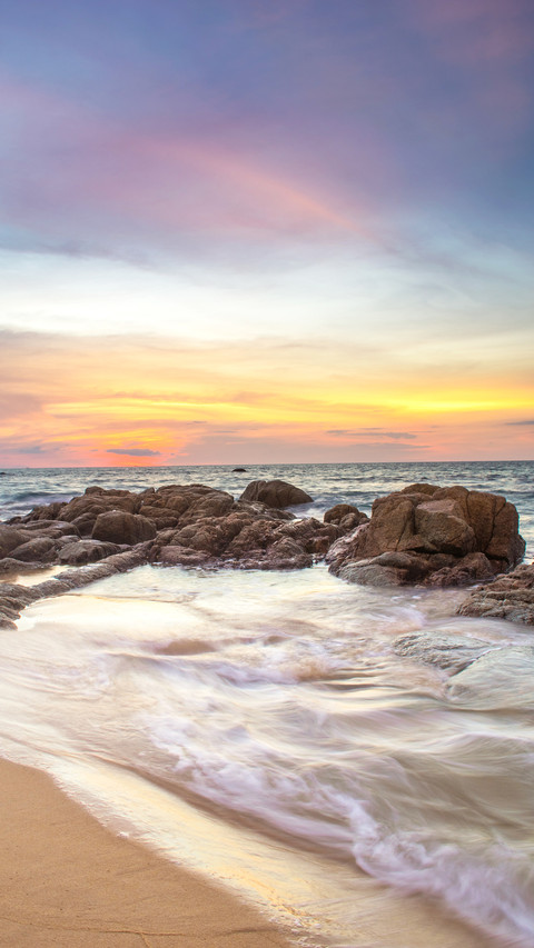 Beach and waves hitting on coast at sunset long exposure screenshot