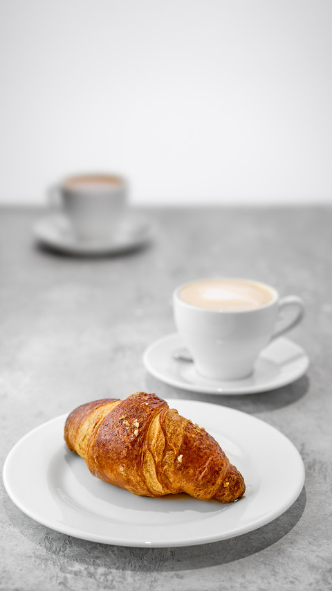 Cappuccino and croissant on a table screenshot