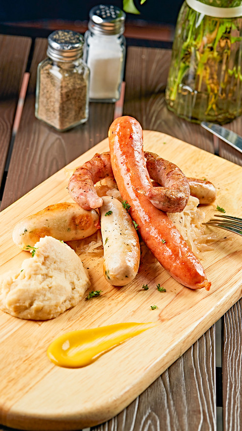 German sausage with pickled cabbage and mashed potato screenshot