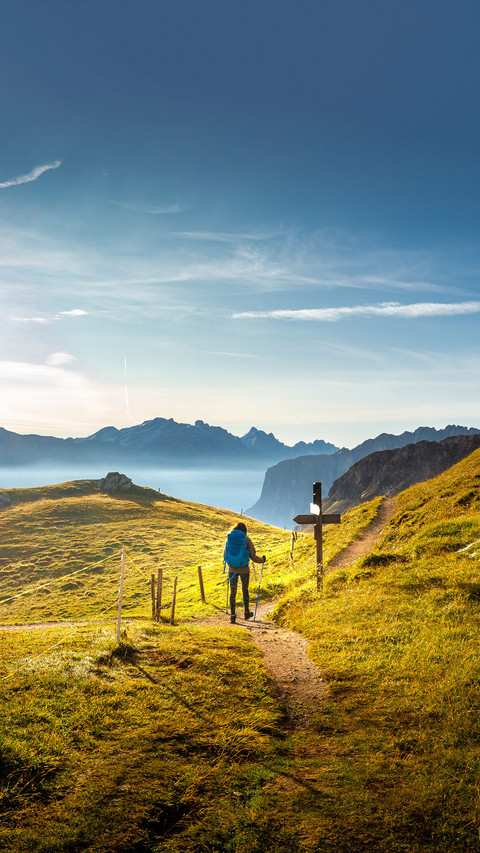 Woman backpacker tourist hiking walking alone mountain screenshot