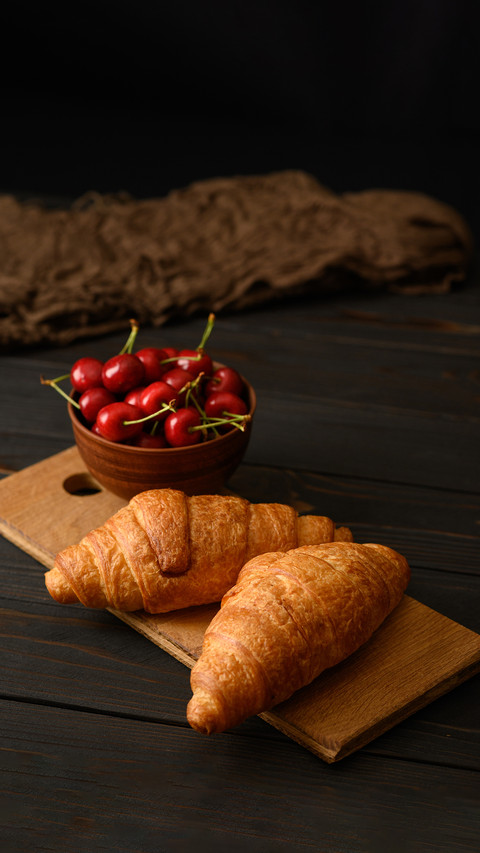 Croissants with Cherries on a Rustic Background screenshot