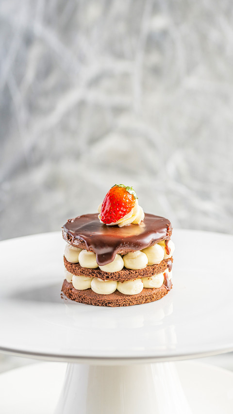 Piece of cake with cream and berries on a white plate screenshot