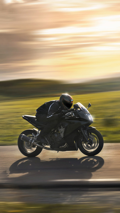Man Riding a Sports Motorbike at Sunset screenshot