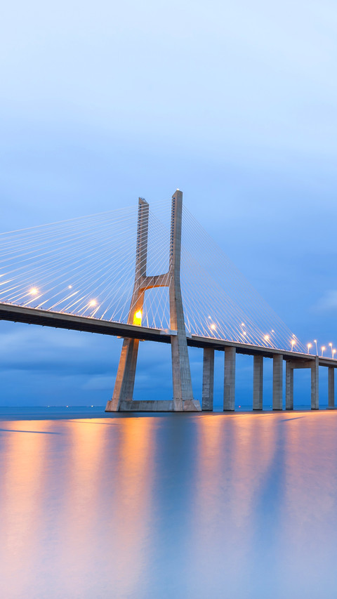 Vasco da Gama bridge lit at sunset in Lisbon screenshot